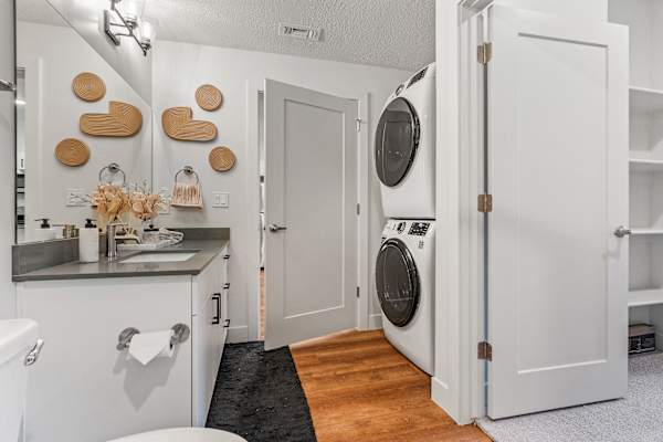 Small white laundry room with a washer and dryer at The Revival, Salt Lake City, UT